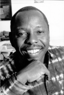 A black-and-white photo of Ken Saro-Wiwa.